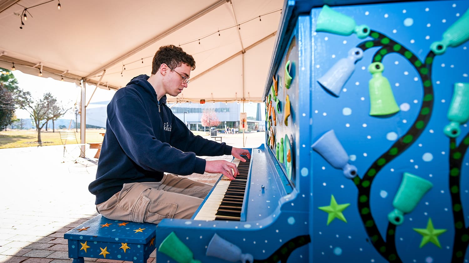 Andrew Farkas plays the piano located on The Oval at NC State's Centennial Campus.