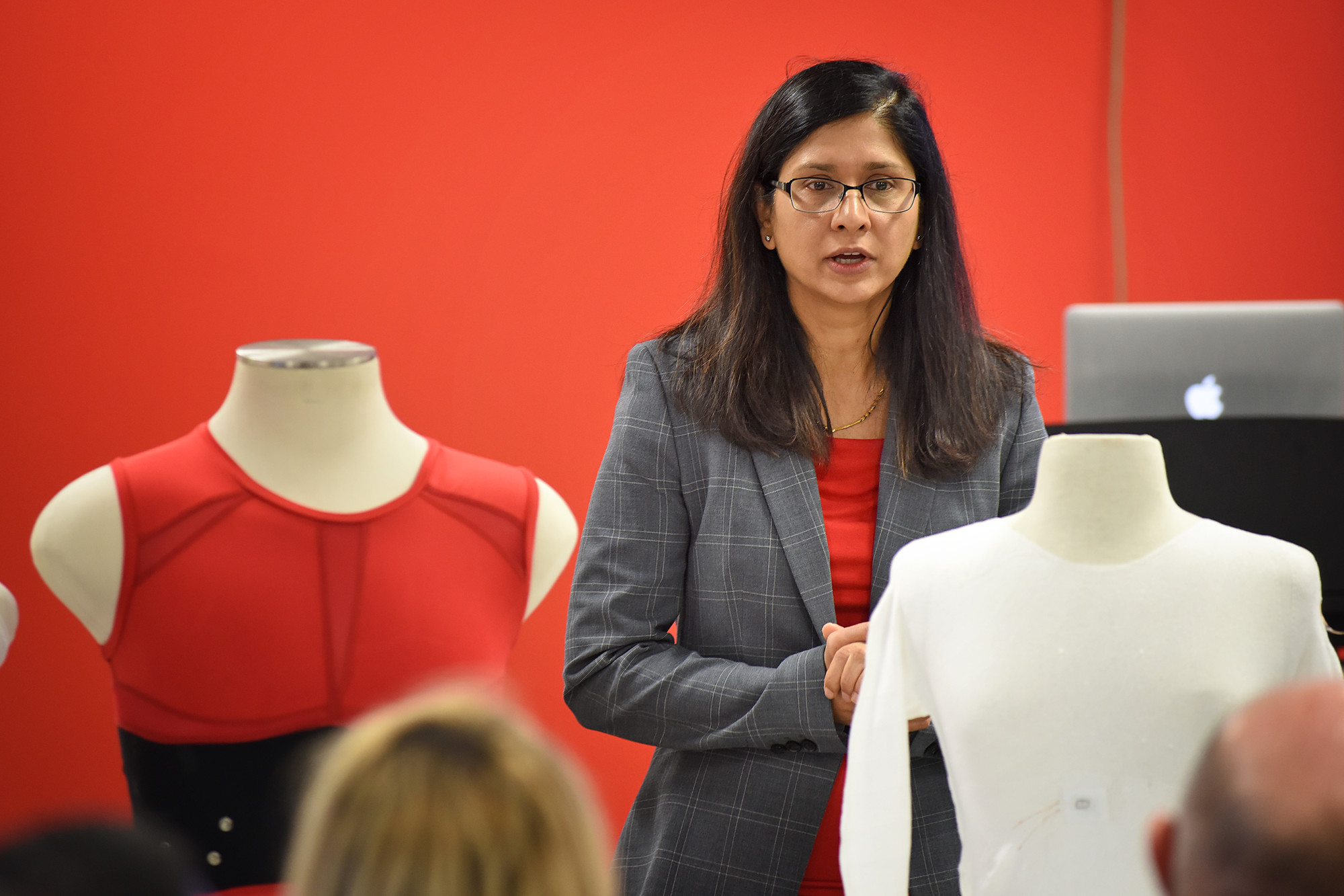 Veena Misra speaks at front of a class.