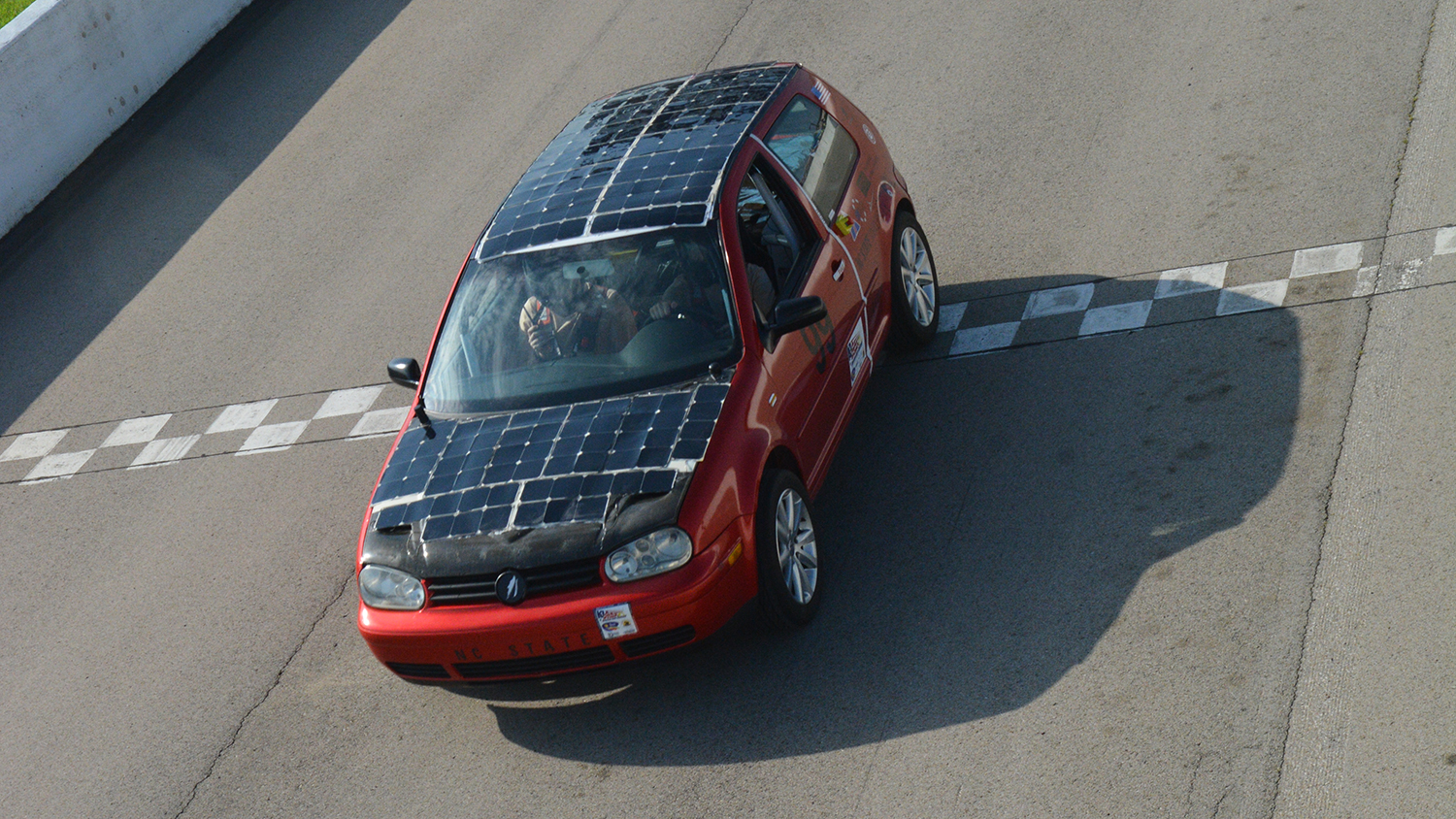 Overhead view of the SolarPack car crossing the finish line.