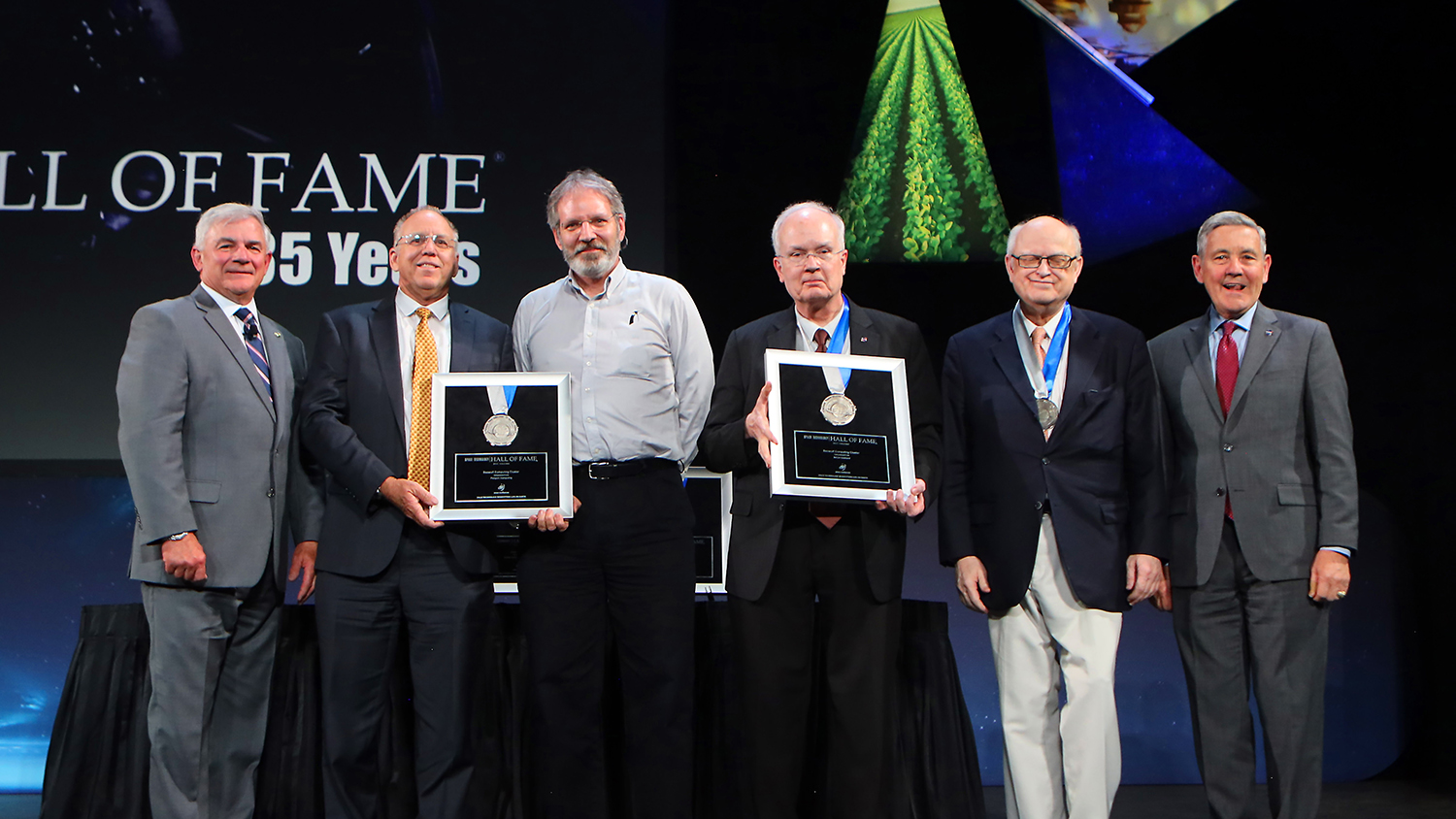 Fischer, third from right, at the 2022 Space Technology Hall of Fame induction ceremony with T. E. Zelibor, Rear Admiral, U.S. Navy (Ret.), CEO Space Foundation; Sid Mair, President and CEO, Penguin Computing; Philip Pokorny, CTO, Penguin Computing; Sterling; and Robert D. Cabana, NASA Associate Administrator.