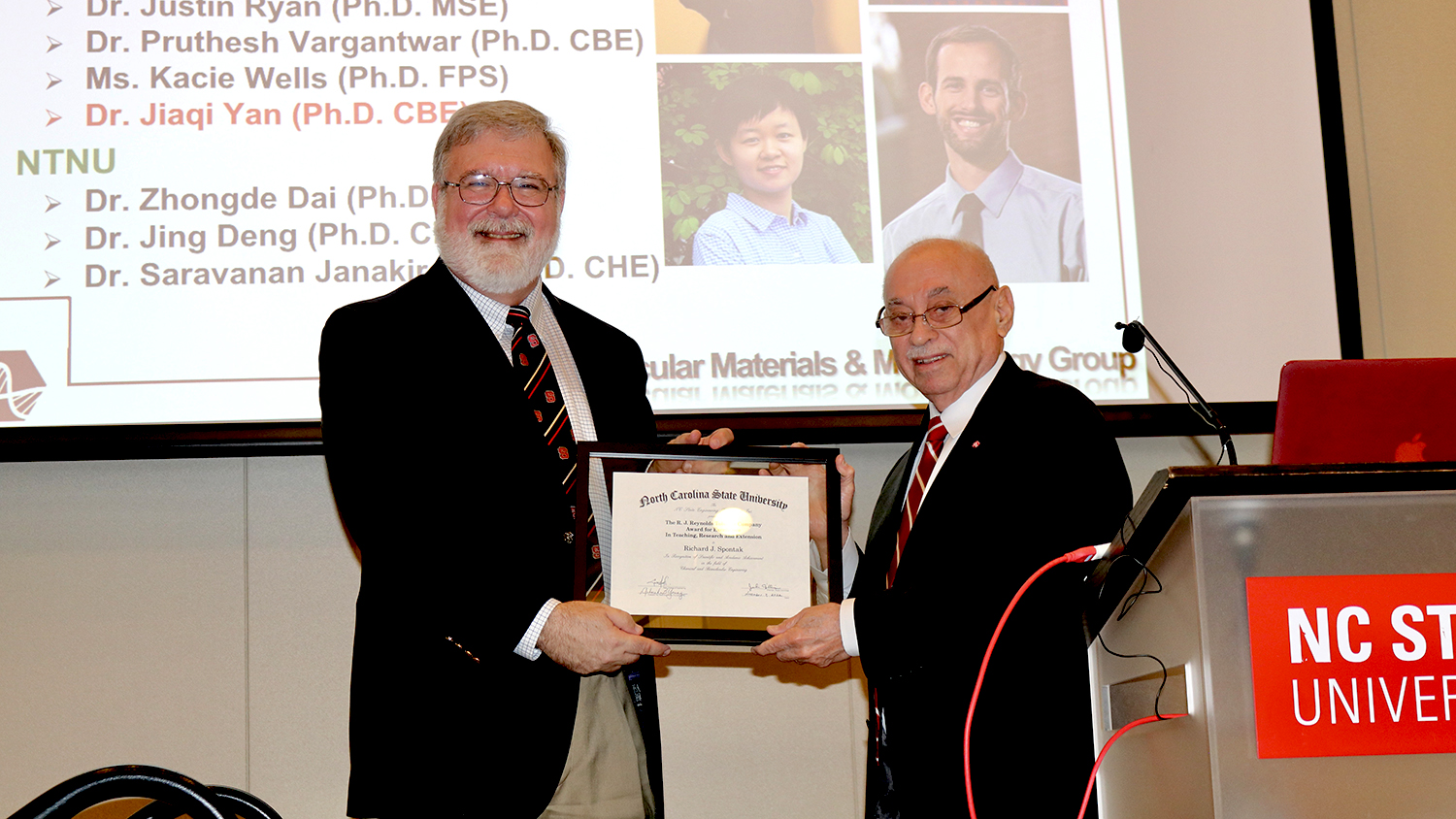 Dean Louis Martin-Vega, right, presents the 2022 RJ Reynolds Award to Richard Spontak.