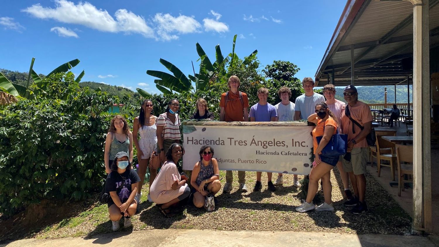 Group of students pose around sign in Puerto Rico.