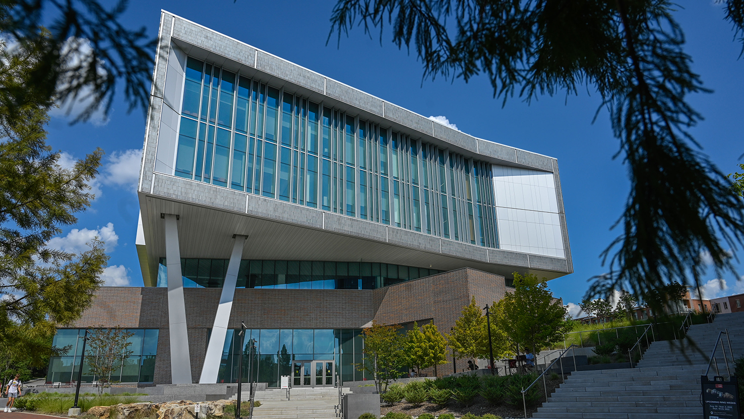 Fitts-Woolard Engineering building on Centennial Campus with tree branches in the edges of foreground.