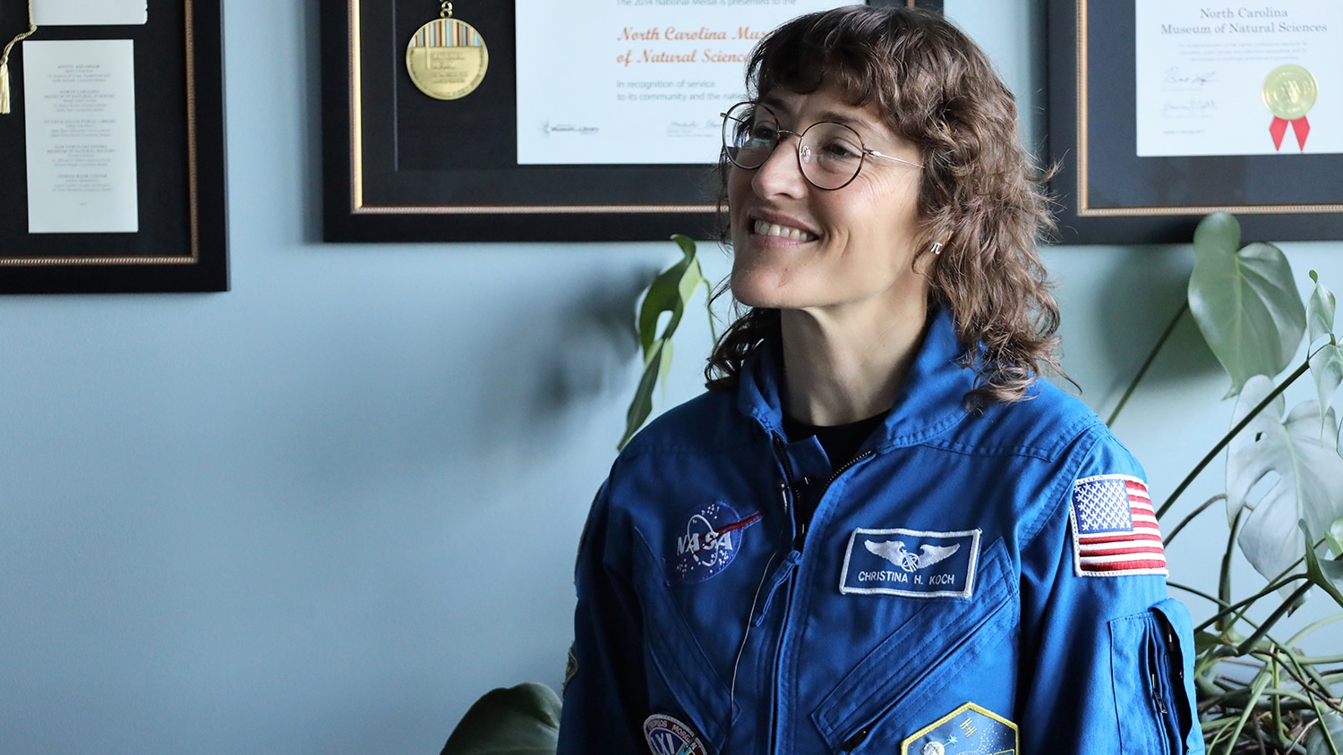 Christina Koch dressed in her blue NASA uniform.