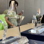 Clear acrylic star-shaped trophies lined up on a table.