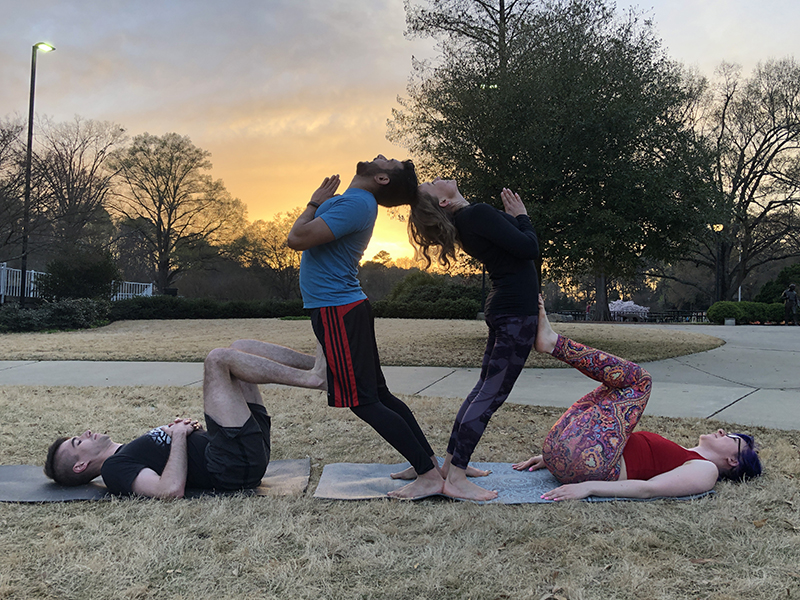Rahul Chakraborty and friends practicing yoga at sunset.