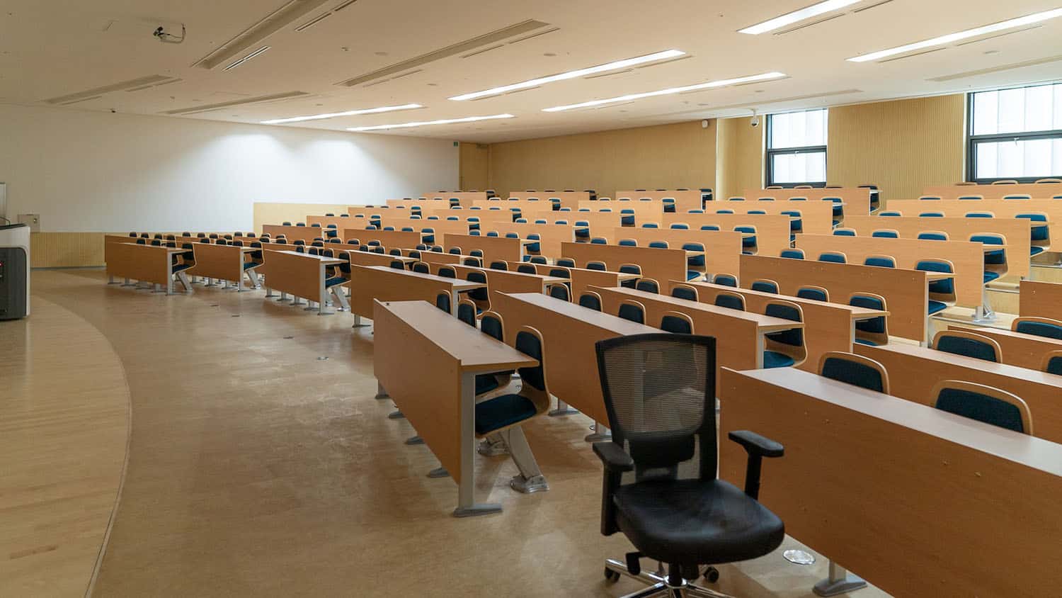 Image shows an empty university classroom.