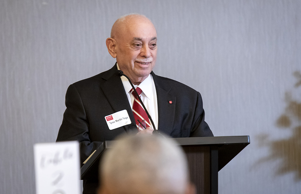 Dean Louis Martin-Vega speaks from behind a lecturn.