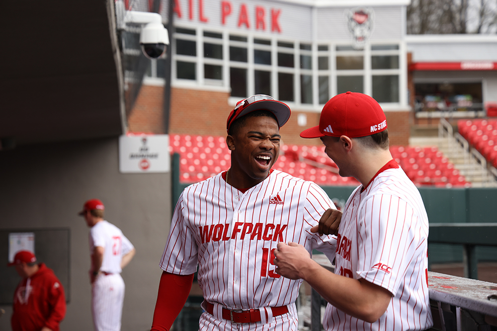 Michael Gupton and teammate share a laugh in the dugout.