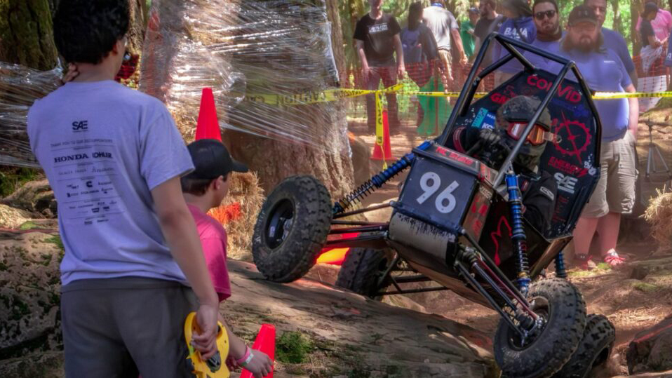 The NC State University Pack Motorsports Baja SAE Team vehicle navigates a course obstacle.