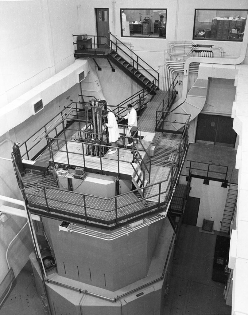 Researchers stand atop the PULSTAR reactor at NC State University.