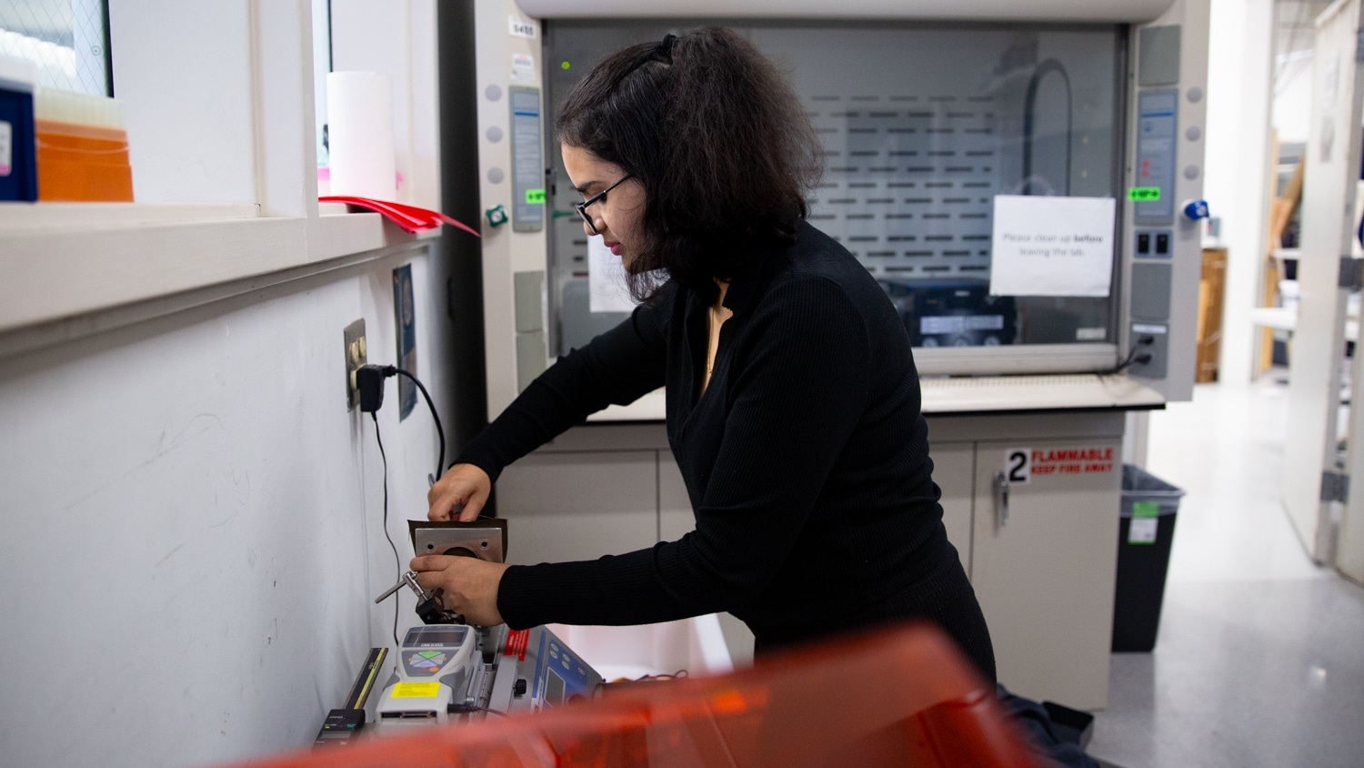 Shourya Lingampally adjusts a machine in a first-floor lab of the Wilson College of Textiles.