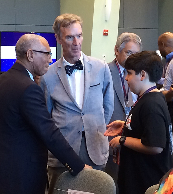 A young Michael Puzio, right, talks with television personality Bill Nye, center, and an unidentified man, left.
