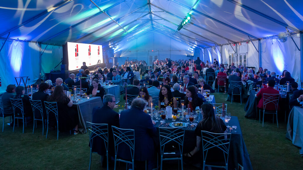 Alumni, faculty, staff, supporters and others gather inside a large tent on Centennial Campus to celebrate the 100th anniversary of the College of Engineering.