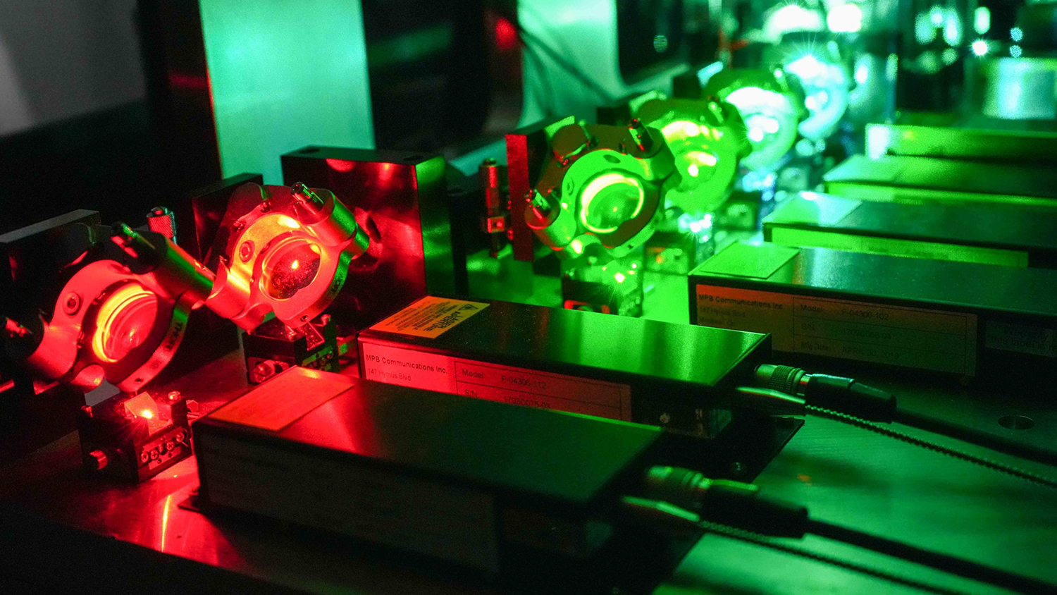 An autonomous microscope bathed in red and green light.