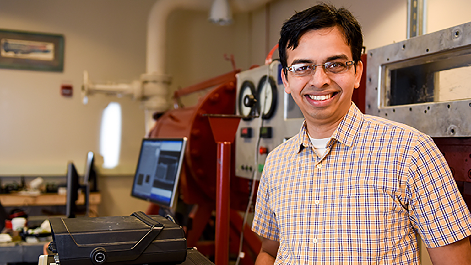 Venkat Narayanaswamy poses for a photograph while standing in his lab.