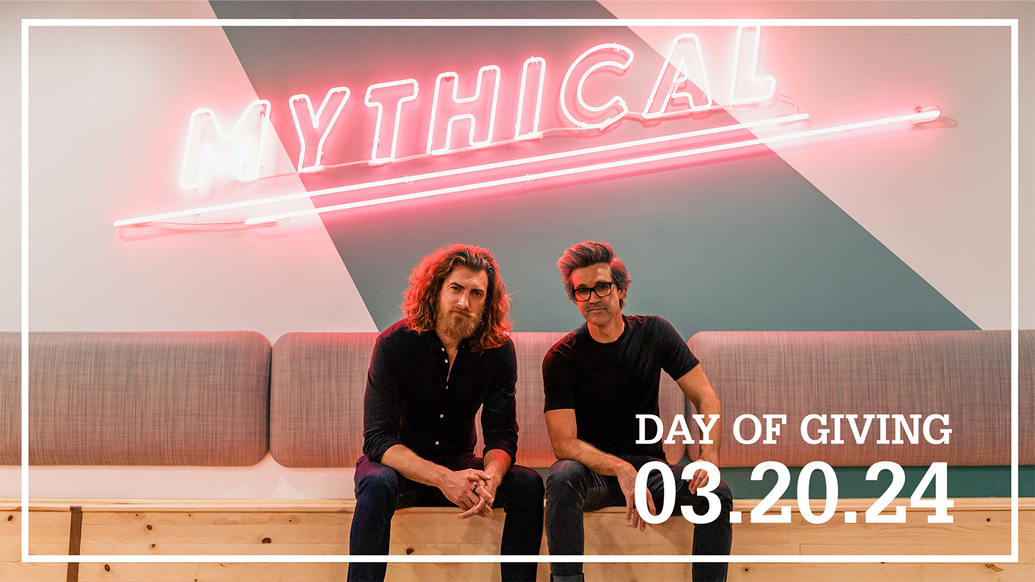 Rhett and Link sit on a couch at Talley Student Union. The word "Mythical" has been superimposed in pink simulated neon letters above them.