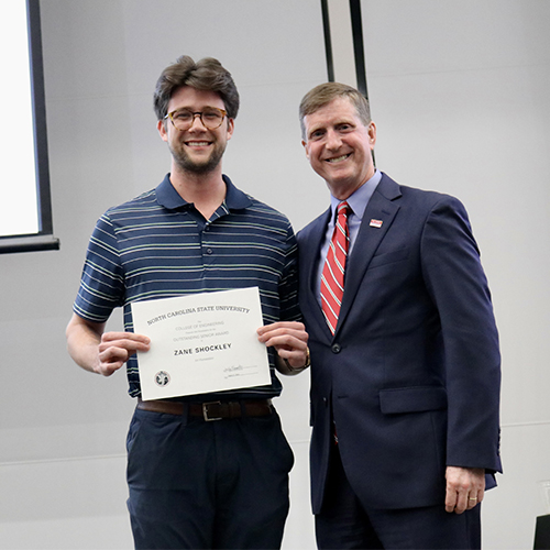 Zane Schockley, left, receives Outstanding Senior Award from Dr. Jerome Lavelle.
