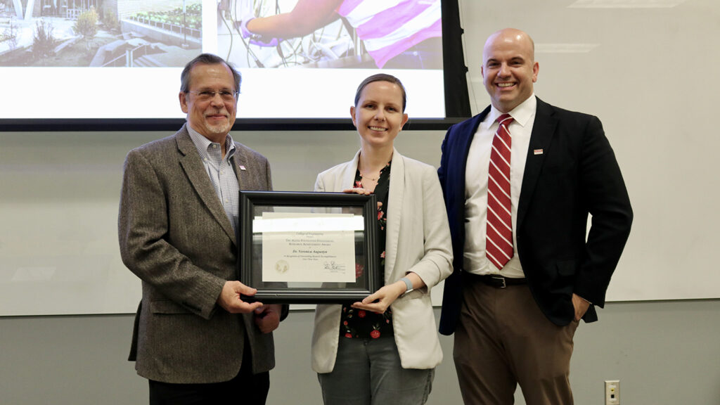 Veronica Augustyn, center, receives the Alcoa Foundation research award from, left, Peter Fedkiw, interim associate dean for research and infrastructure, and Jim Pfaendtner, Louis Martin-Vega Dean of Engineering.