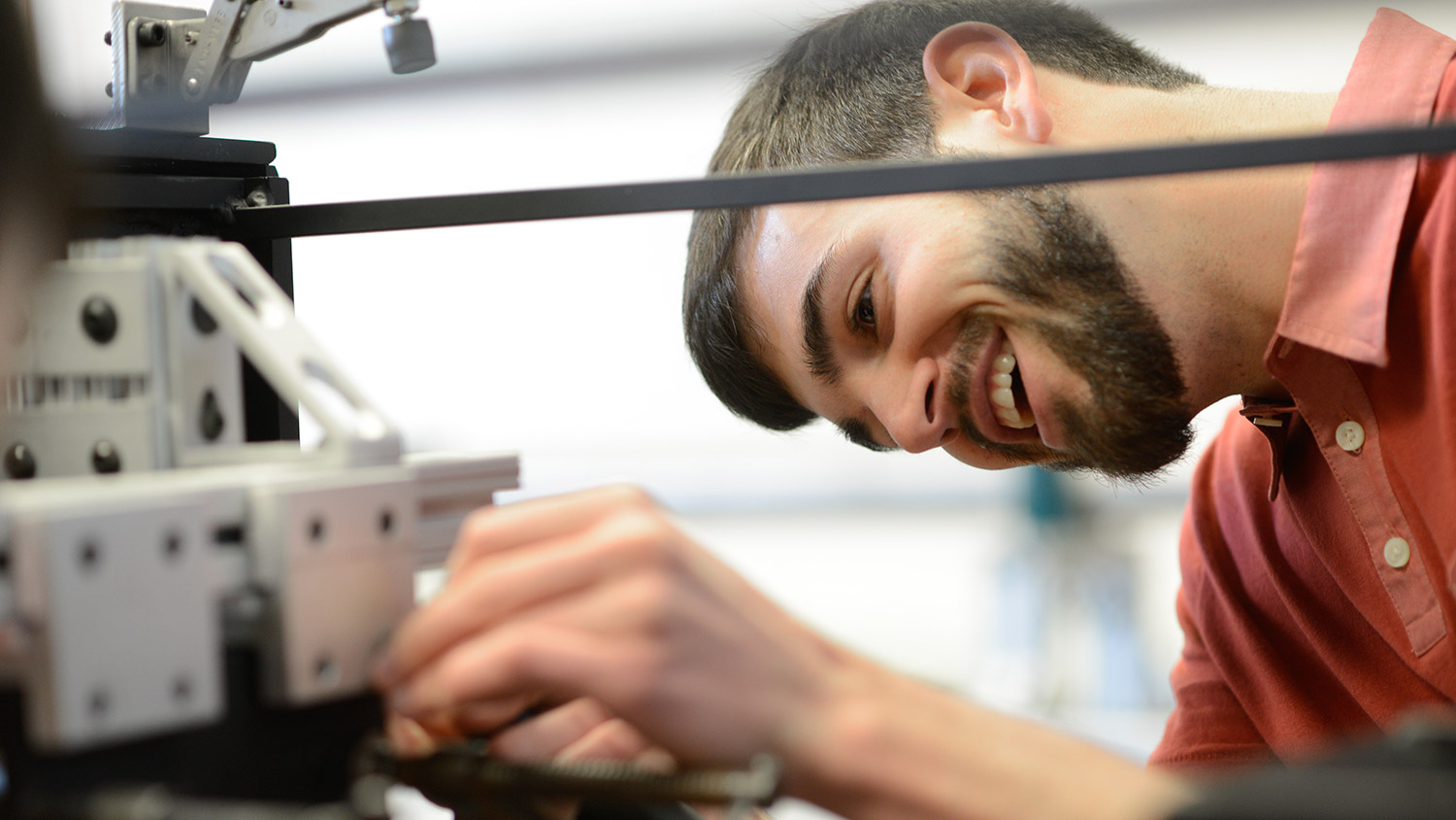 Smiling male student preparing item in the Blast Lab