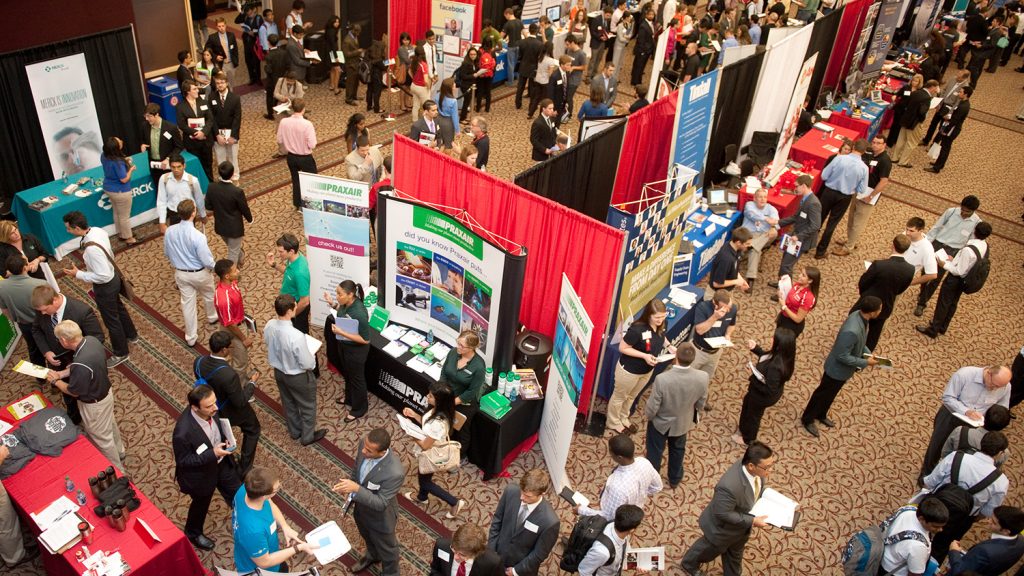Overhead wide-angle photo of attendees at a variety of booths at the Engineering Career Fair 