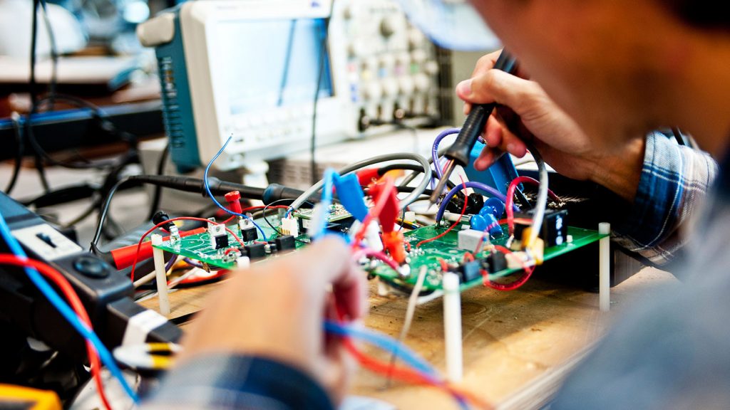 Student works on circuit board.