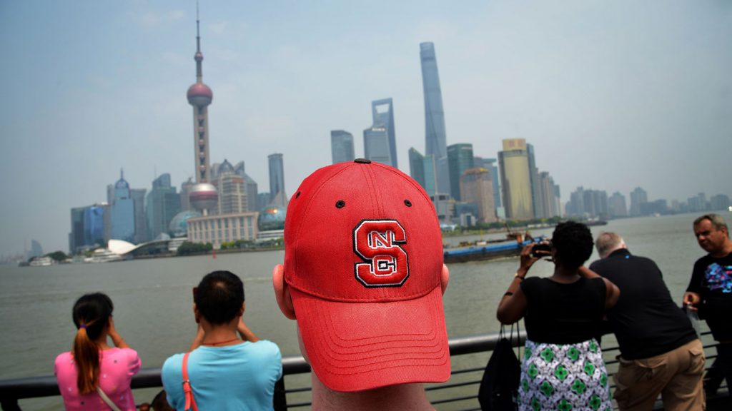 NC State student sports his Wolfpack pride on his head while touring The Bund in Shanghai.