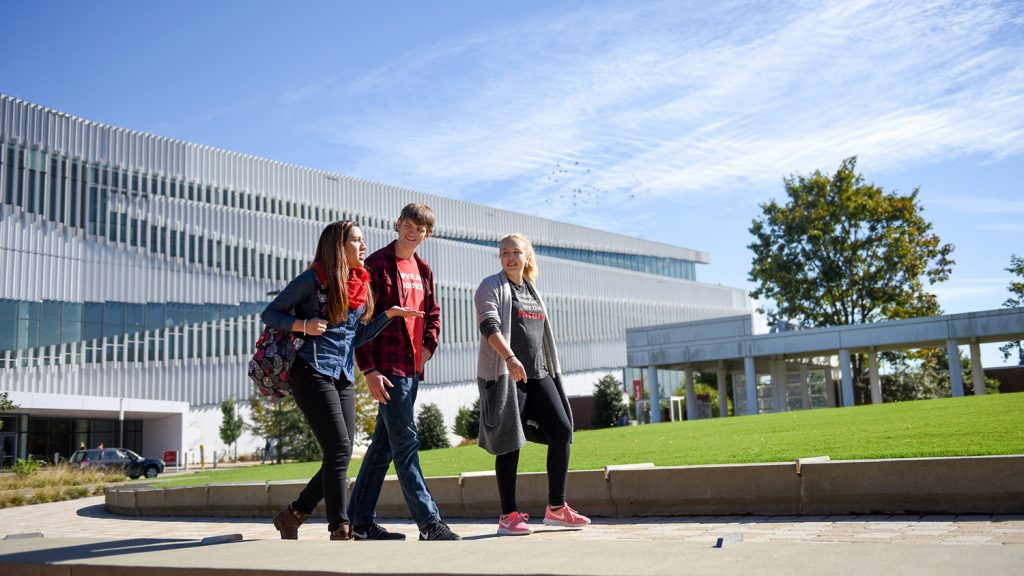 students walking by Hunt Library