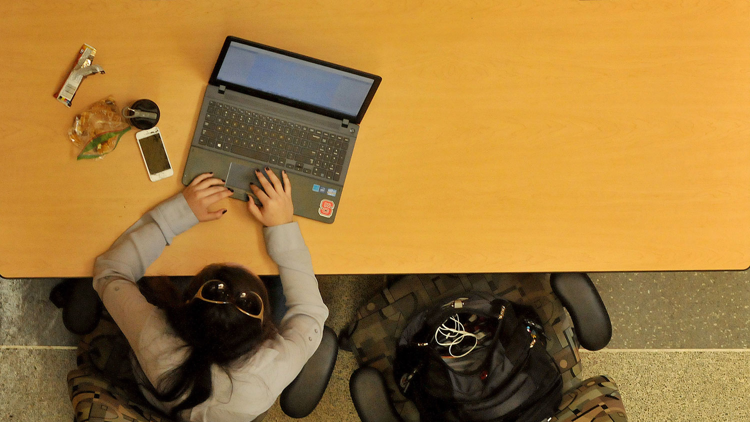 Student works on her laptop in EB1 on Centennial Campus.