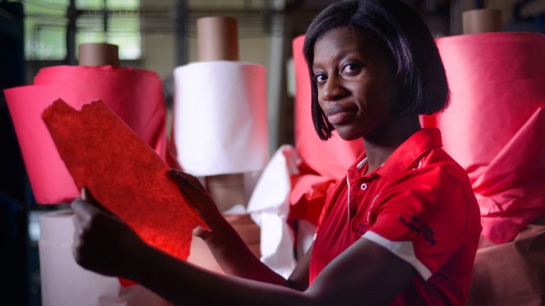 Student Nelessa Lewis inspects paper at The Robertson Pulp and Paper Laboratory.