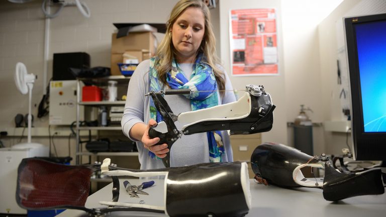 Student examines a rehabilitation device in the Power (GAIT) Lab in EB III.