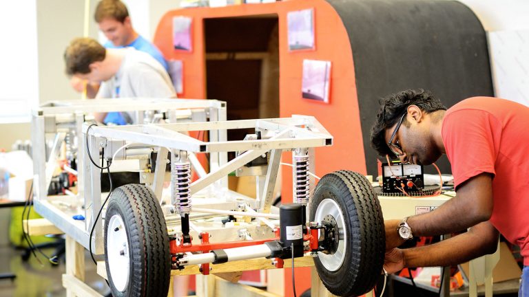Students work on an EcoPRT car. The EcoPRT (ecological personal rapid transit) is an ultra-light and low-cost transit system featuring autonomous two-person cars that would drive on a guideway railing system.