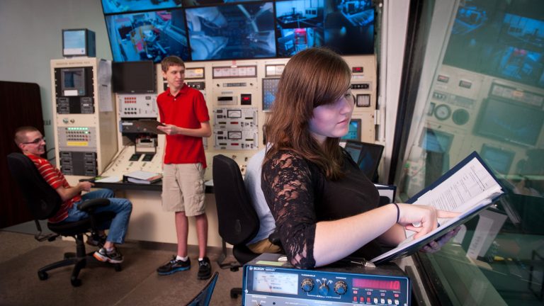 Nuclear engineering students work in the Nuclear reactor control room in Burlington Labs.