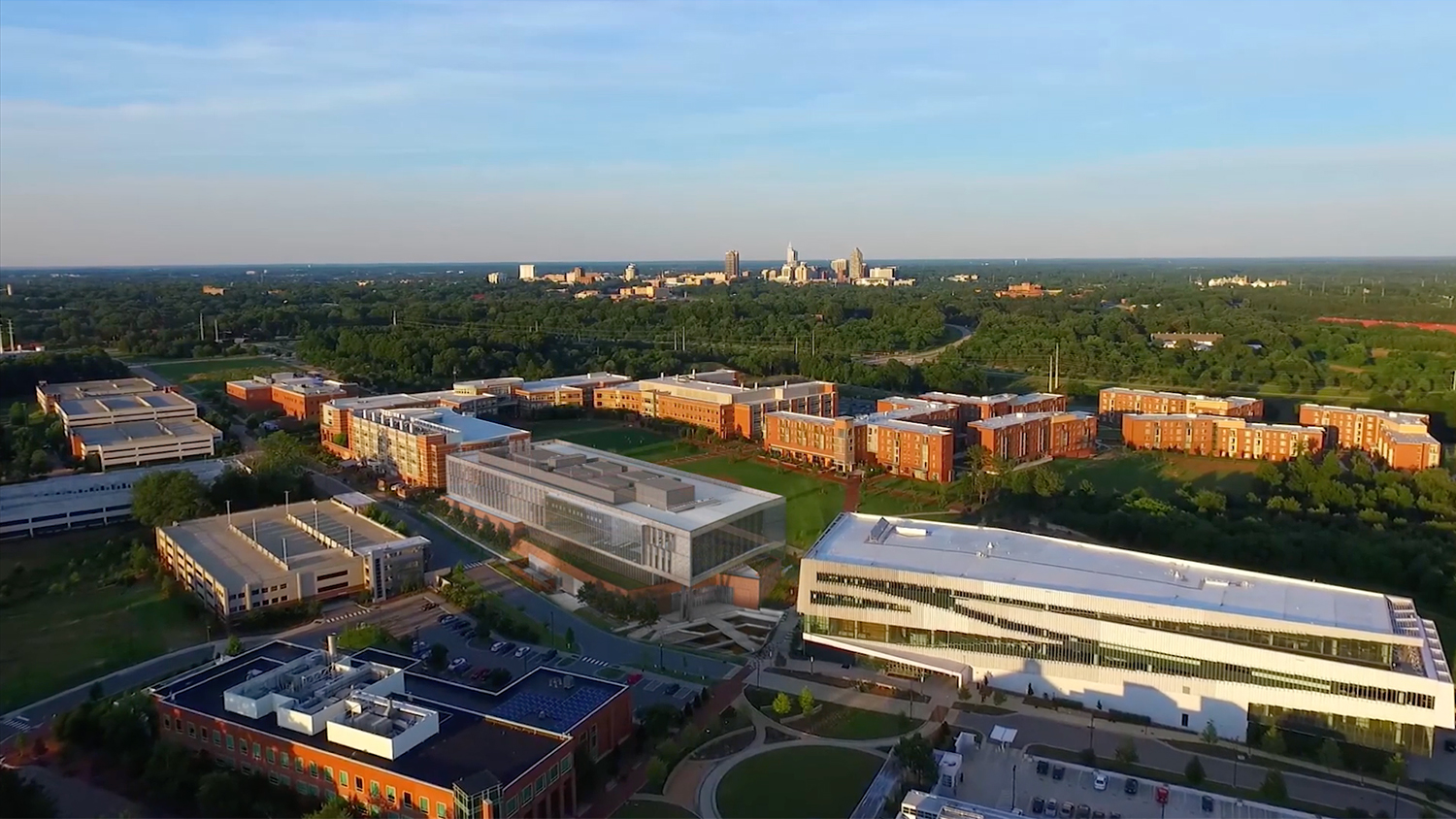From the video is a fly-over image of the Engineering Oval on Centennial Campus with an image of the future Fitts-Woolard Hall superimposed on it.